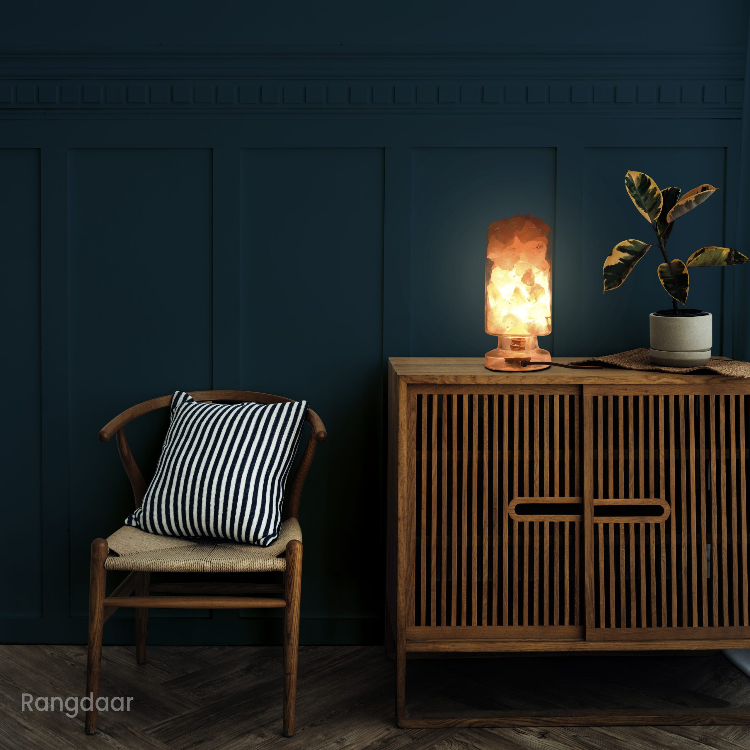 Scandinavian vintage wood cabinet with chair by a dark blue wall